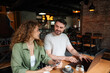 © Jelena - Young entrepreneurs working together on a laptop in a cafe