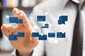 Modern businessman interacts with digital email network.  Concept of global communication and networking.