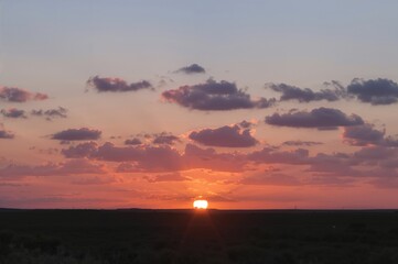 Wall Mural - The evening sky is adorned with a mesmerizing blend of gentle, fading colors at sunset.