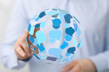 Man interacting with digital sphere of speech bubbles. Communication, global network and technology concept for stock photography platforms.