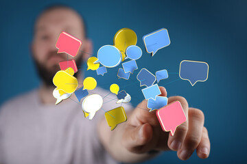 man touching floating speech bubbles, representing communication, connection, and online interaction