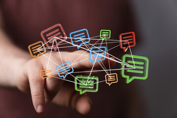 Close-up of a person's hand interacting with interconnected message bubbles. Illustrating communication, digital connectivity, and network relat