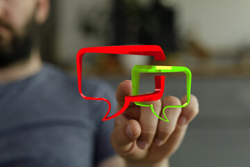 Conceptual stock photo of a man touching stylized speech bubbles. Ideal for illustrating communication, messaging, and modern digital interactio