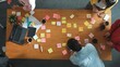 © InfiniteFlow - Top view of skilled business people discuss plan at meeting room while writing idea at sticky notes and stick at whiteboard. Group of diverse team working together to planning strategy. Convocation.