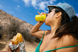 © Mal de Ojo Studio/Stocksy - Woman Enjoying Refreshments on Vacation
