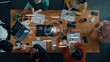 © InfiniteFlow - A group of diverse professionals collaborates in a modern office, sharing ideas and insights on AI-driven analytics, surrounded by data visualizations and technology tools. Trope