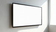 © Viktor - Modern widescreen display monitor with blank white panel screen mounted on light wall. Sunlight streams from window, casting shadow. Empty digital template ready for content in bright, clean office