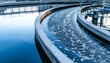 © Studicon - The image shows a curved channel of a water treatment facility with water flowing through it, and some froth visible on the surface.
