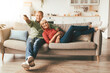 © Prostock-studio - Relaxed Senior Couple Watching Television Together Sitting On Sofa And Pointing Remote Controller Switching Channels Relaxing At Home On Weekend. TV Programming Concept