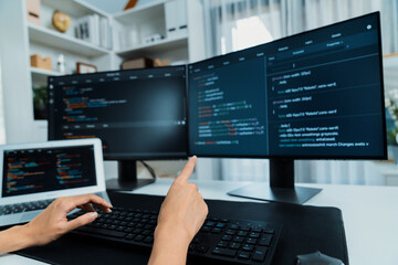 Cropped hands image of IT developer creating with typing information on pc with coding program information data website application, wearing jeans shirt surround safety analysis two screen. Stratagem.