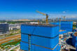 © Yic Ma/Stocksy - Aerial view of construction site with concrete formwork and cranes