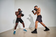 © Javier Díez/Stocksy - Two boxers sparring in a minimalistic training space