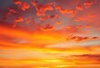 © chanwut - Blazing orange and red hues paint the sky at dawn/dusk, clouds ablaze with fiery light,  dawn,  heat