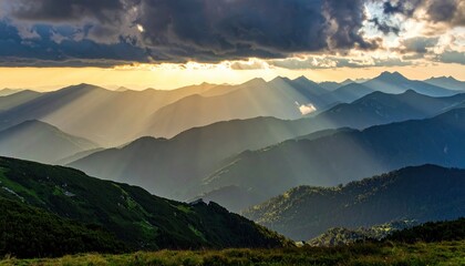 Wall Mural - Serene mountain landscape at sunset with rays of light illuminating the valleys and distant peaks
