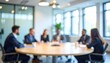 © Hyejin Kang - Blurry group of various experts is having a roundtable meeting in the conference room.