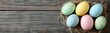 © jianhua - Colorful Easter Eggs in a Nest on Wooden Tabletop
