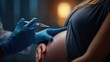 © Anna - Close-up: Medical Professional Injecting a Vaccine into a Pregnant Woman's Arm
