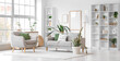 © Pixel-Shot - Interior of light living room with grey sofa, armchair and green plants