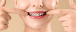 © Pixel-Shot - Young woman with dental braces smiling on beige background, closeup