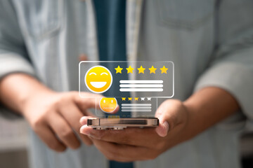 Canvas Print - Customer giving 5-star rating on smartphone screen with smiley emoji icon, symbolizing excellent user feedback, satisfaction review, and positive digital reputation.