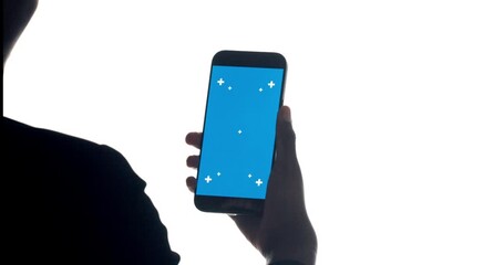 Hand, phone and click green screen in studio with mock up space for user experience on white background. Person, smartphone and display with empty ui, scroll and test with mobile app development