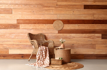 Wall Mural - Interior of stylish living room with wicker armchair and artificial flowers on coffee table