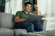 © panitan - asian man work using computer hand typing laptop keyboard contact us.student study learning education online.adult professional people chatting search at office.concept for technology device business