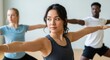 © Sarwar - Diverse group of people practicing yoga in a bright studio, focusing on mindful movement and wellness