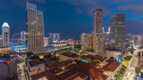 Evening panorama with Marina Bay area and skyscrapers city skyline aerial day to night timelapse.