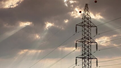 Wall Mural - High voltage transmission tower against dramatic cloudy sky, electricity pylon time lapse footage, moving clouds and changing light conditions, power grid infrastructure and energy distribution