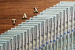© OlegD - Wooden letters with the inscription tax and $100 American paper bills on table, top view, closeup. Tax text with money dollars on wooden background
