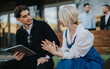© qunica.com - A professional discussion between colleagues outside in a relaxed yet business-oriented environment