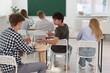 © New Africa - Students taking exam at wooden table indoors