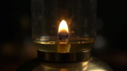 Wall Mural - A vintage oil lamp's flame flickers and gradually diminishes as the oil level drops, showing the passage of time in an atmospheric timelapse diminishes, romantic, interior