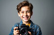 © starush - A smiling boy holding a camera ready to take a picture