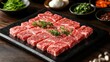 © MBRAMO - Raw beef slices on a stone plate, Korean BBQ setting