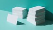 © ni - A stack of glossy white cards sits beside another pile on a turquoise office desk with an additional card standing uprig