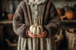 © D - Autumn Coziness with Small Pumpkin in Child's Hands