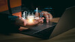 © PRIM - Engineer using laptop with holographic smart factory system showing industrial technology, automation, and innovation in manufacturing process for digital industry and future engineering concept.