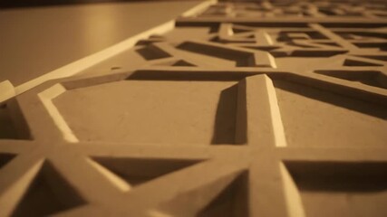 Sticker - A slow cinematic dolly shot reveals intricate geometric patterns bathed in warm, raking light and deep shadows raking, dark, serene
