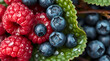 © Oksana - Close-up of raspberries and blueberries on a nature background.