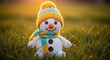 © MST - Adorable knitted snowman wearing a warm winter hat and scarf on a dewy meadow at sunrise