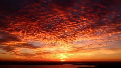 Wall Mural - Dynamic cloud patterns form a mesmerizing grid across the sky during a beautiful sunset timelapse relaxation, purple sky, peaceful