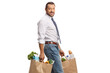 © Ljupco Smokovski - Businessman walking with grocery bags and looking at camera