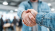 © Your Hand Please - Close-up of business handshake between professionals in an office, symbolizing teamwork, successful negotiations, and business mergers or acquisitions.
