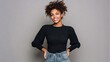 © Johannes - portrait of young african american woman standing with hands on waist and looking at camera confident stylish black girl standing against grey background happy afro girl smiling with copy space no lo