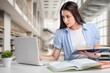© BillionPhotos.com - Dedicated Female Student Learning at Modern Library.