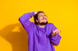 © deagreez - Confused young man in a purple hoodie gesturing with frustration against a vibrant yellow background