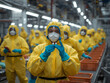 © Denny - People in protective suits working at a line processing hazardous biohazard materials.
