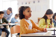 © Home-stock - Concentrated smart African American school girl looking at blackboard during lesson at private school. New academic semester year